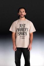 Person wearing a beige t-shirt with Just Women's Sports text