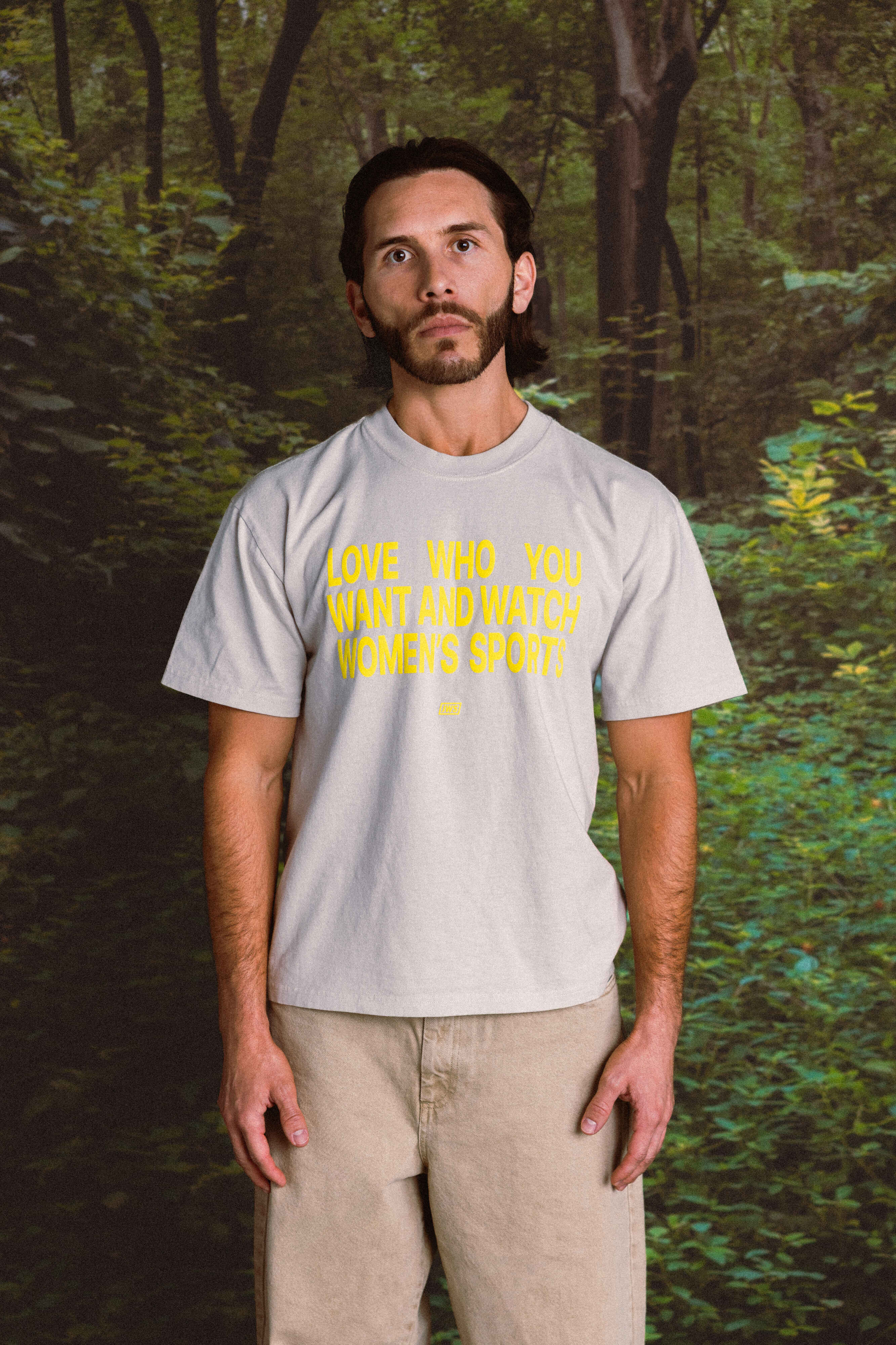 Person wearing a t-shirt with a motivational quote in a forest setting