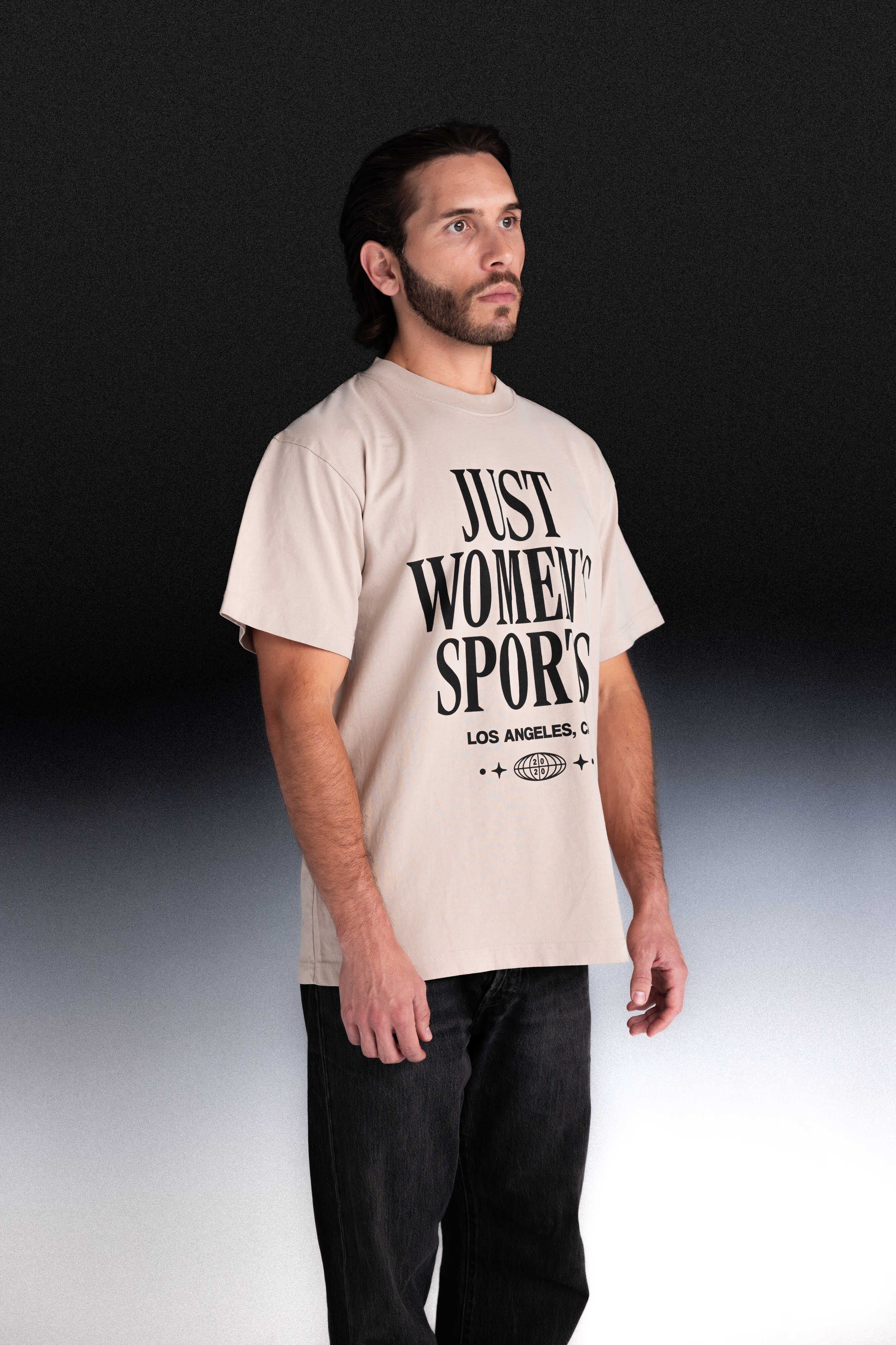 Person wearing a beige t-shirt with text
