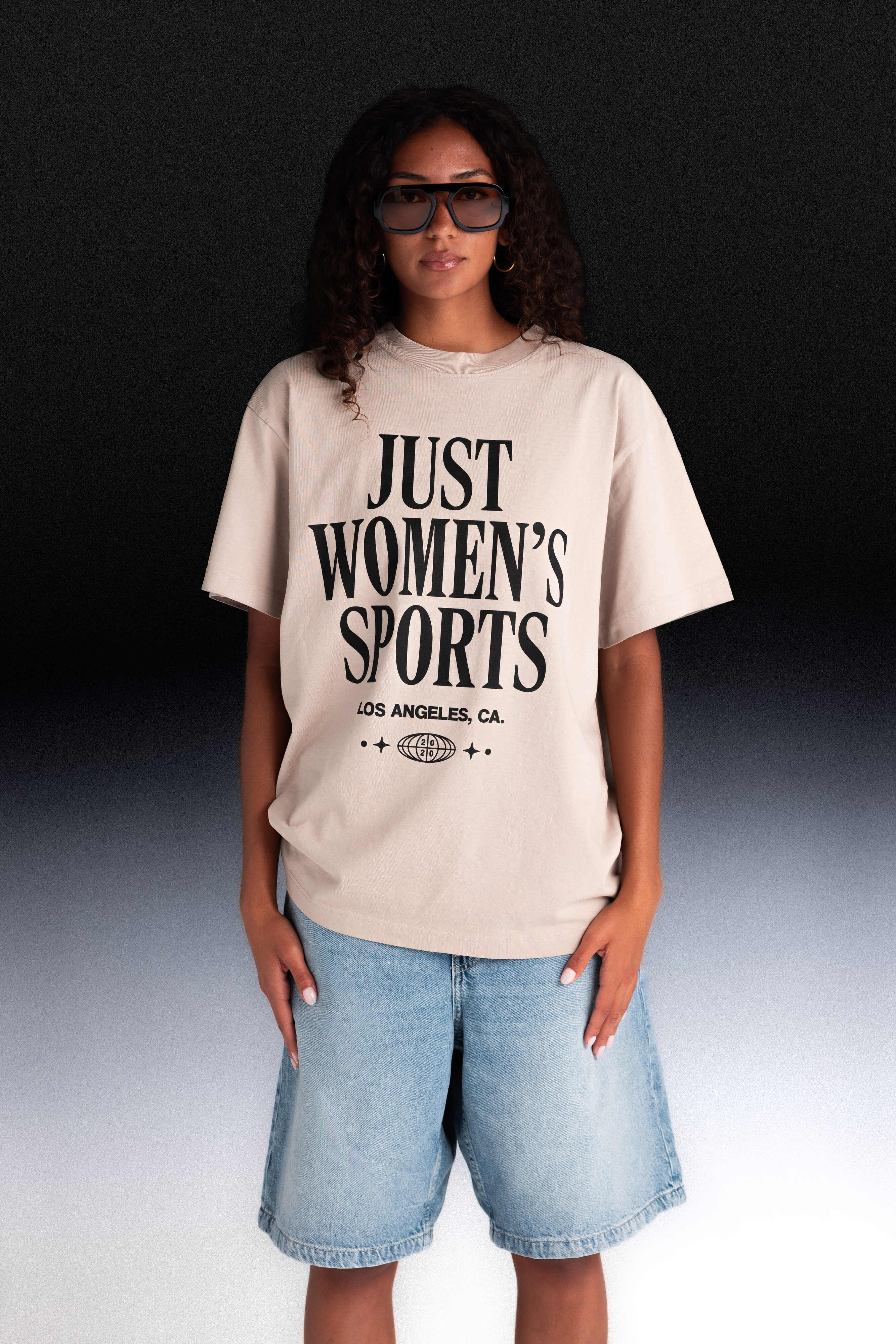 Person wearing a beige t-shirt with Just Women's Sports text
